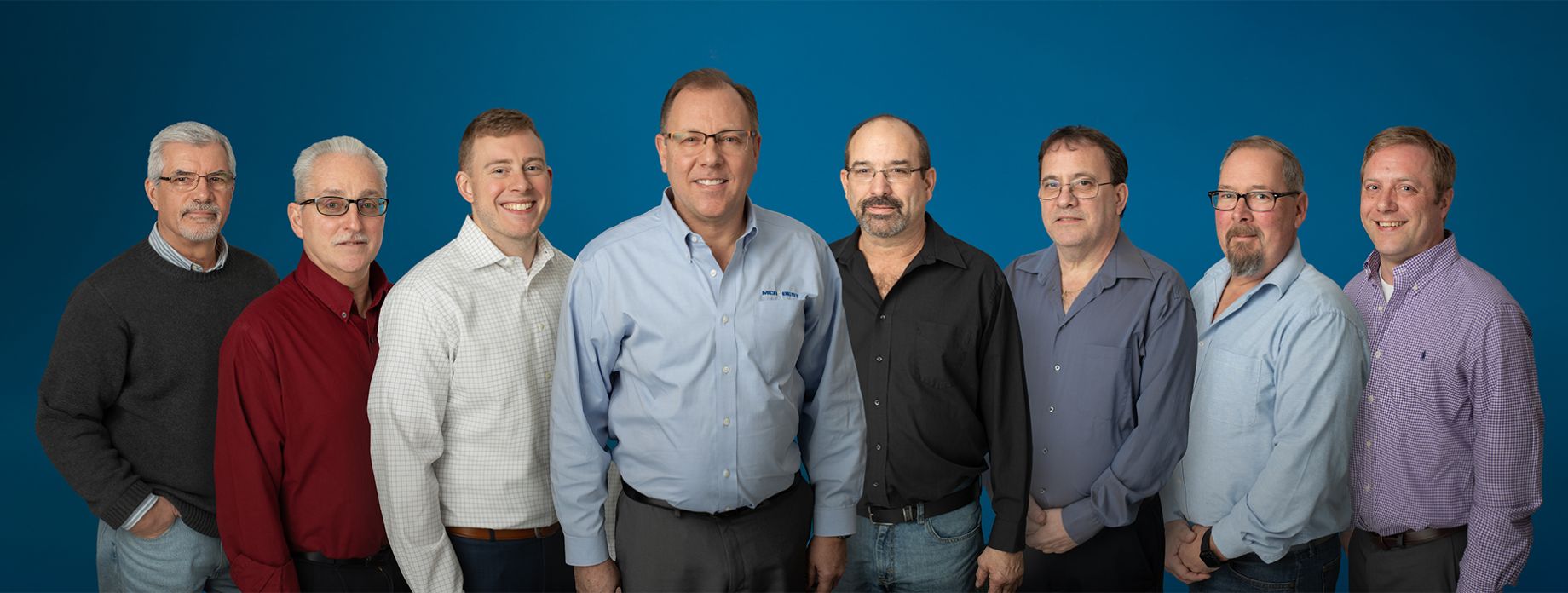 Eight members of the Microbest Leadership team smiling.
